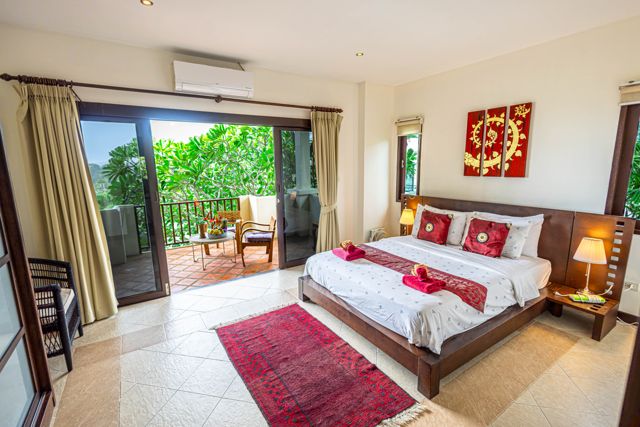 Bedroom with balcony and red throw